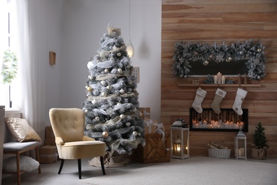 Festive interior with beautiful Christmas tree and gifts