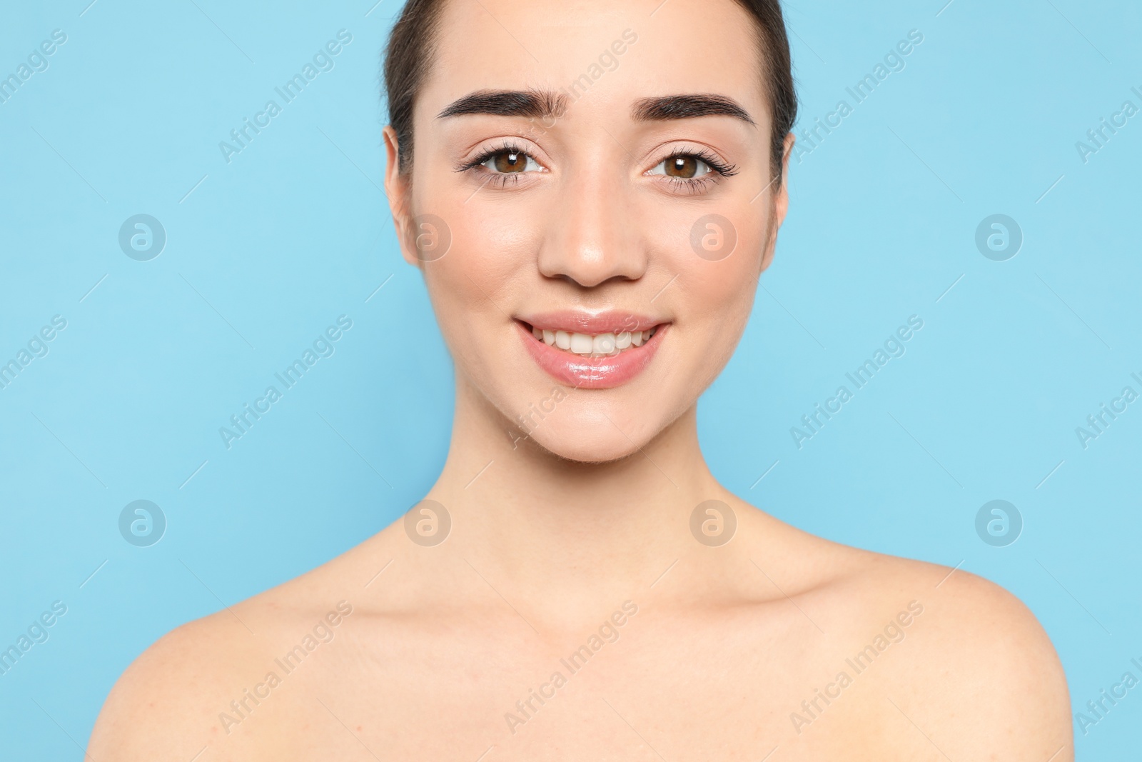 Photo of Portrait of young woman with beautiful face against color background