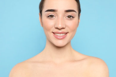 Photo of Portrait of young woman with beautiful face against color background