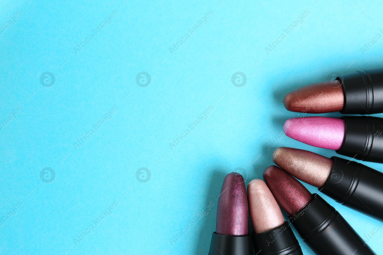 Photo of Flat lay composition with different stylish lipsticks on color background, space for text