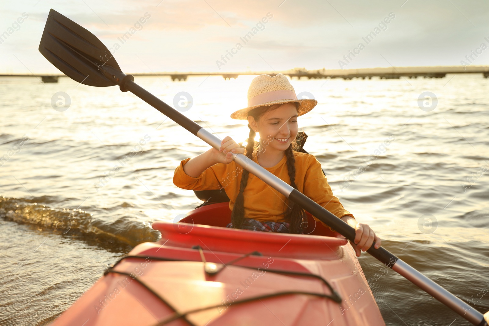 Photo of Happy girl kayaking on river. Summer camp activity