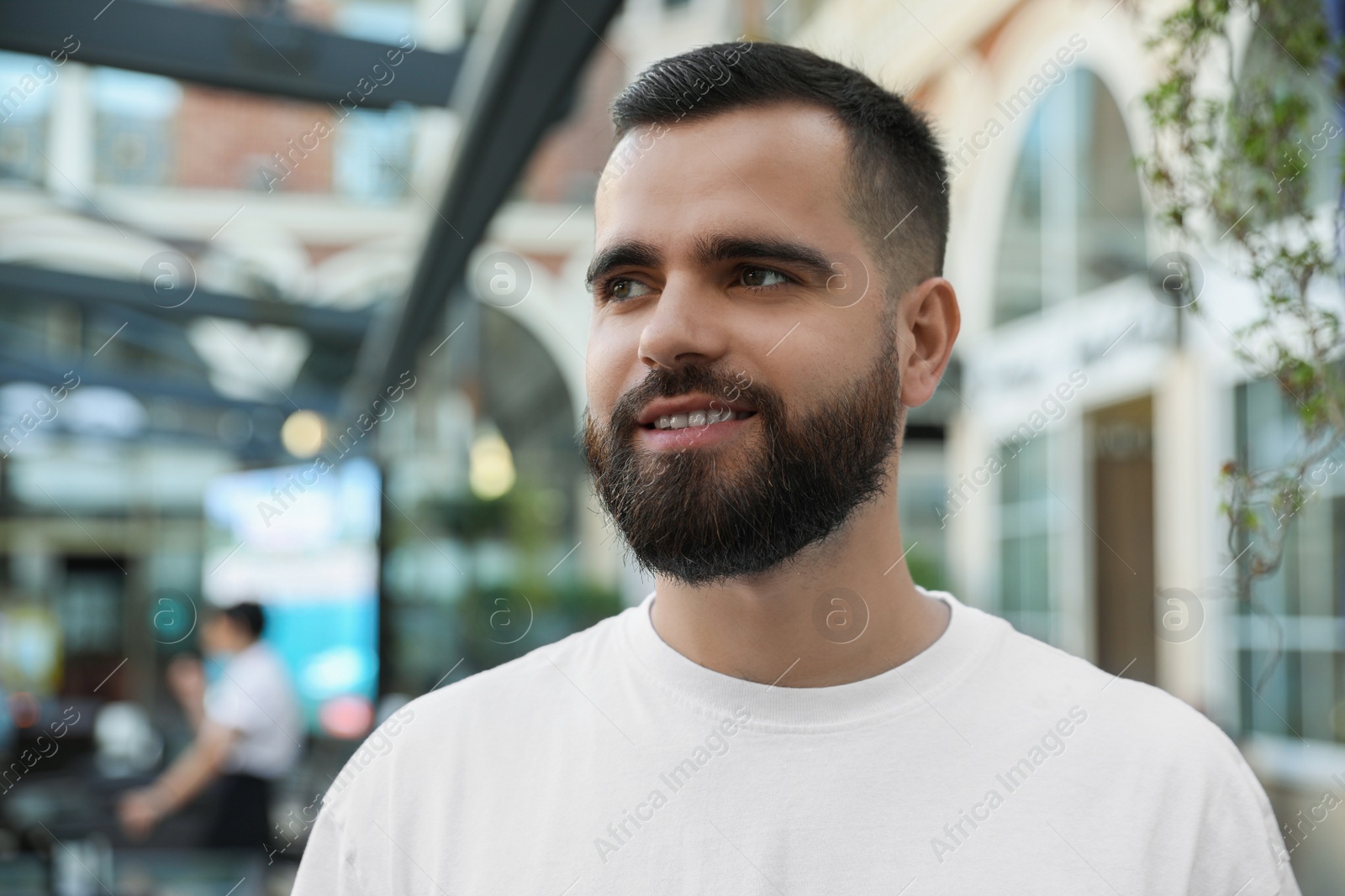 Photo of Portrait of happy handsome man on city street