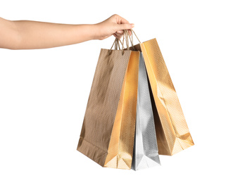 Woman holding paper shopping bags on white background, closeup. Space for design