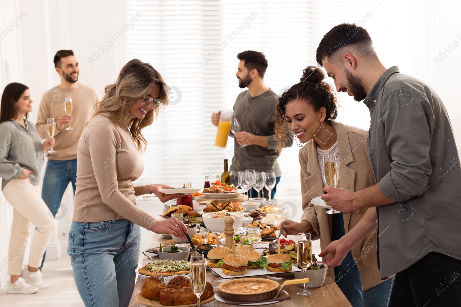 Photo of Group of people enjoying brunch buffet together indoors