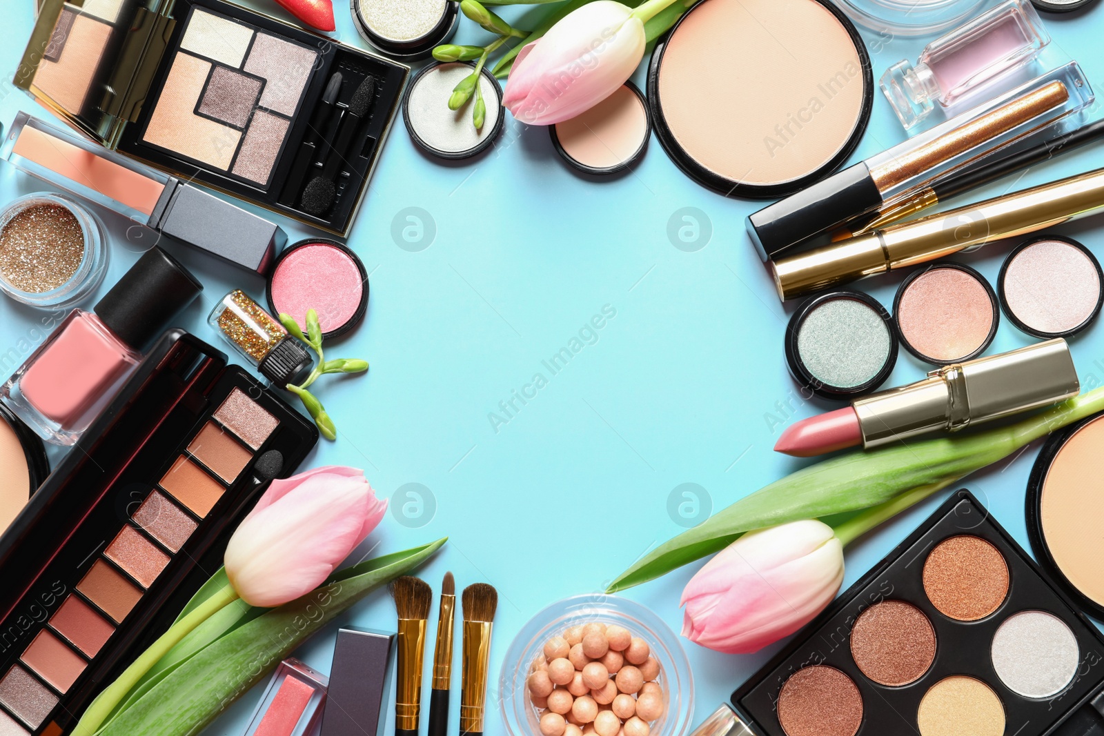 Photo of Different makeup products and flowers on color background, flat lay with space for text