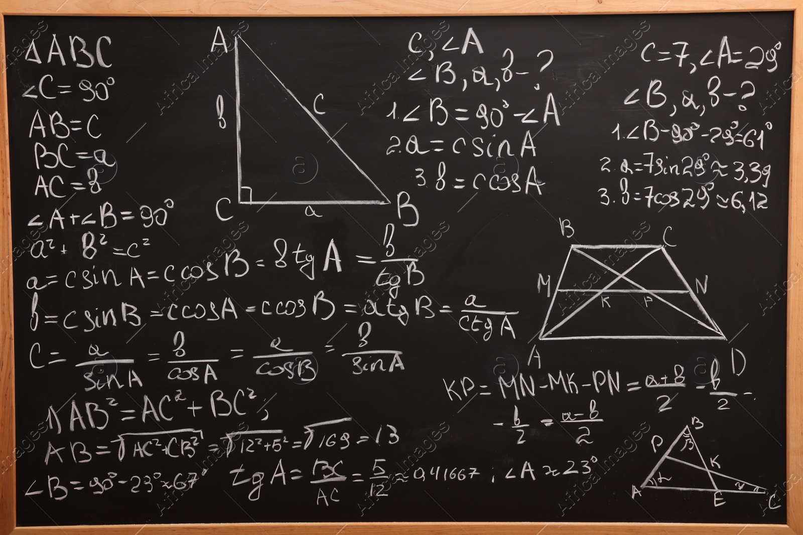 Photo of Different mathematical formulas written with chalk on blackboard