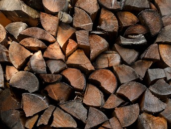 Pile of dry firewood as background, closeup