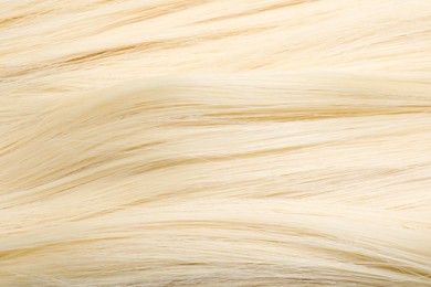 Photo of Beautiful blonde straight hair as background, closeup