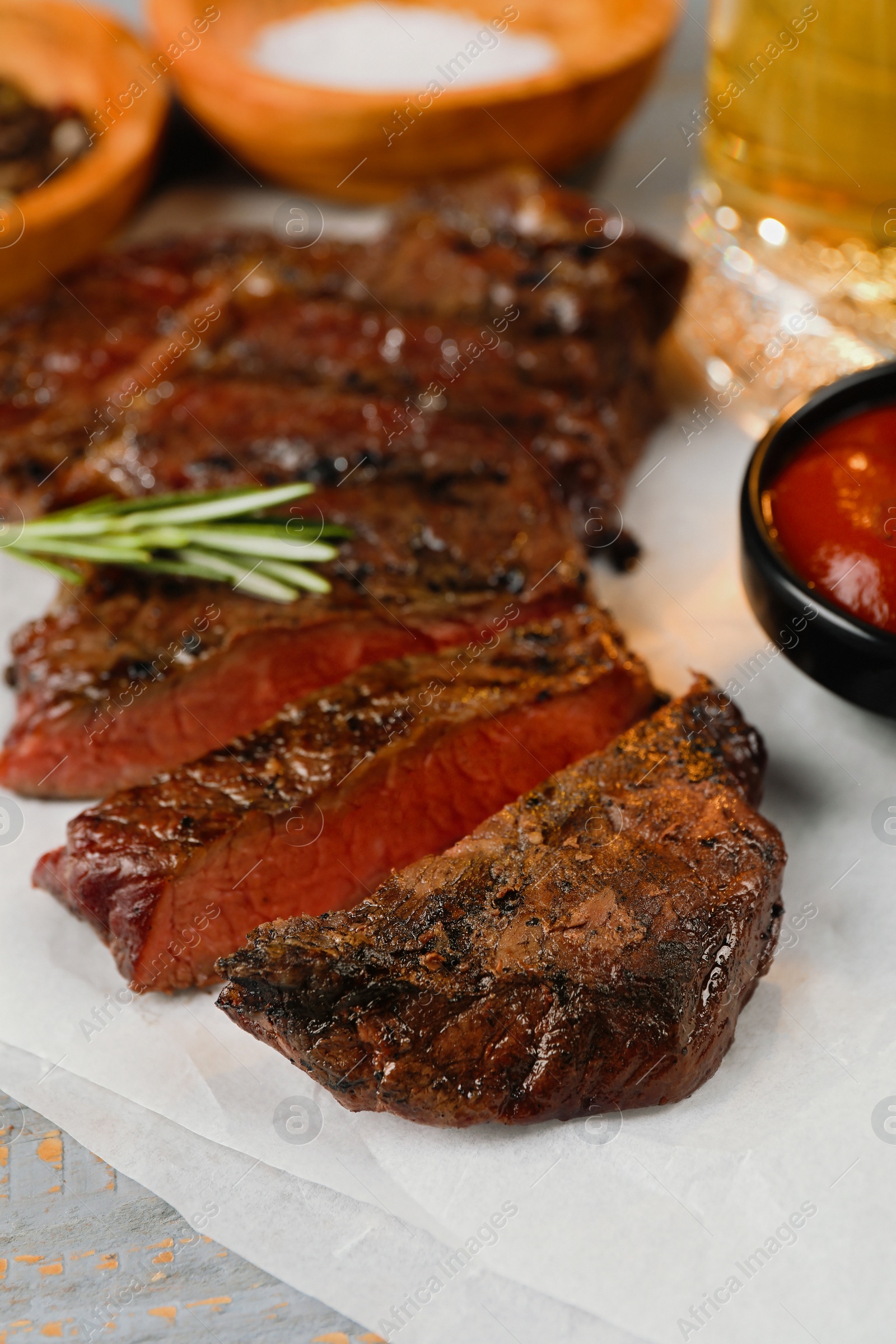 Photo of Delicious fried steak served on grey wooden table, closeup