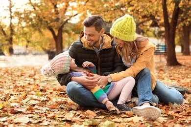 Photo of Happy family with child together in park. Autumn walk