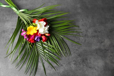 Photo of Beautiful freesia bouquet on grey background