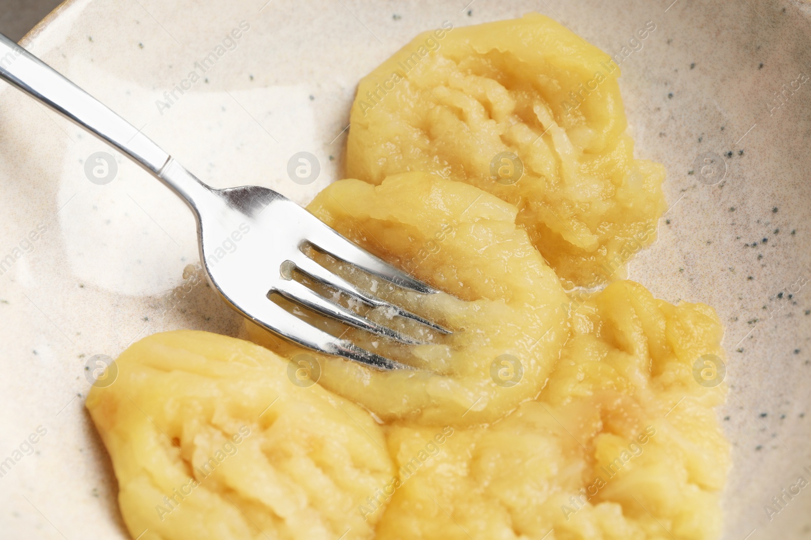 Photo of Fresh apple puree in plate ready for freezing, closeup