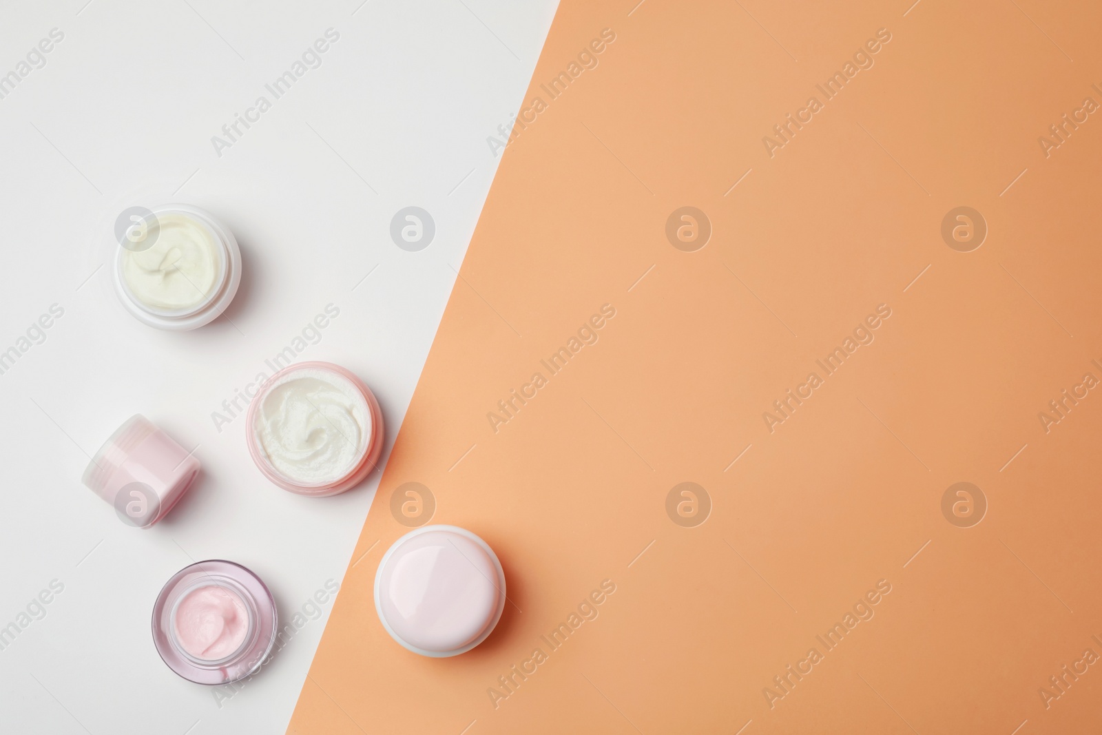 Photo of Flat lay composition with cosmetic products on color background