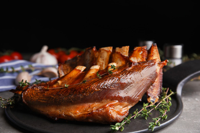 Photo of Delicious roasted ribs served on plate, closeup