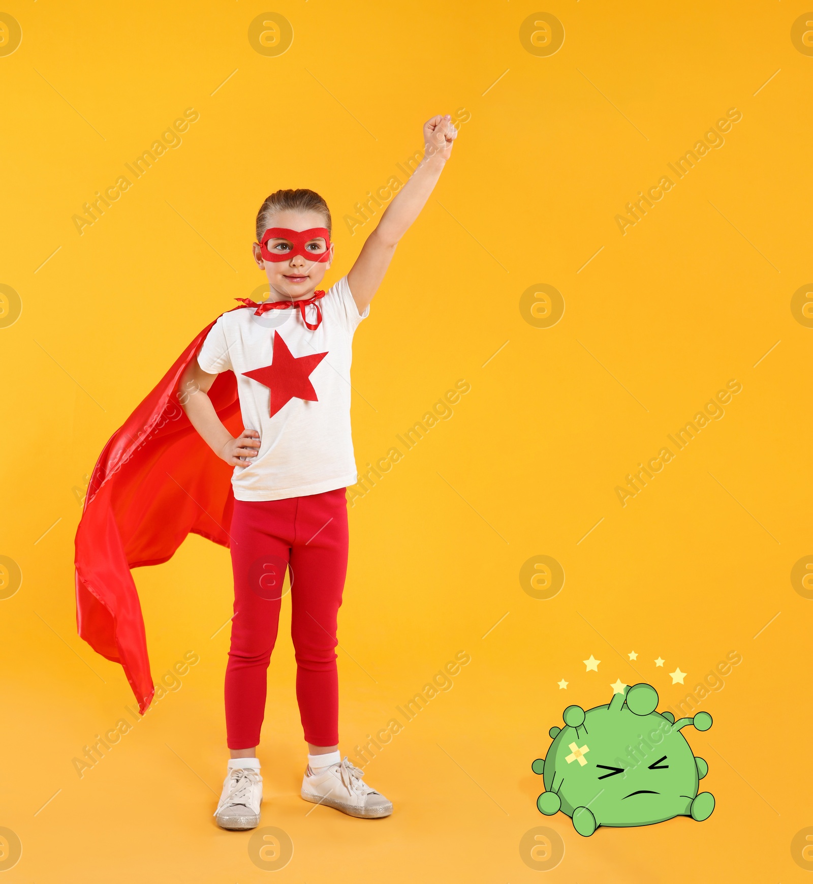 Image of Little girl wearing superhero costume won in fight against virus on yellow background