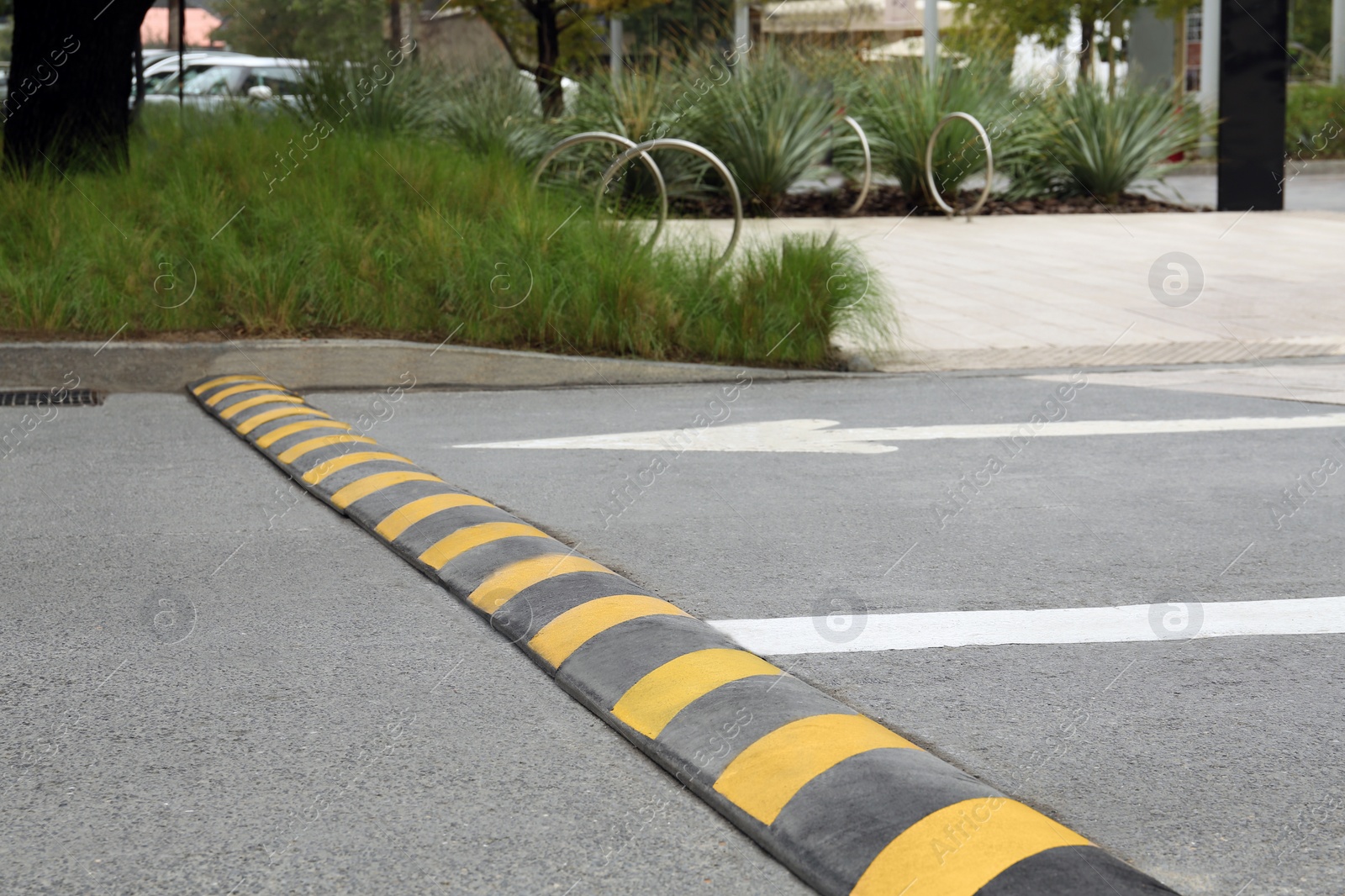 Photo of Striped speed bump on street. Road safety