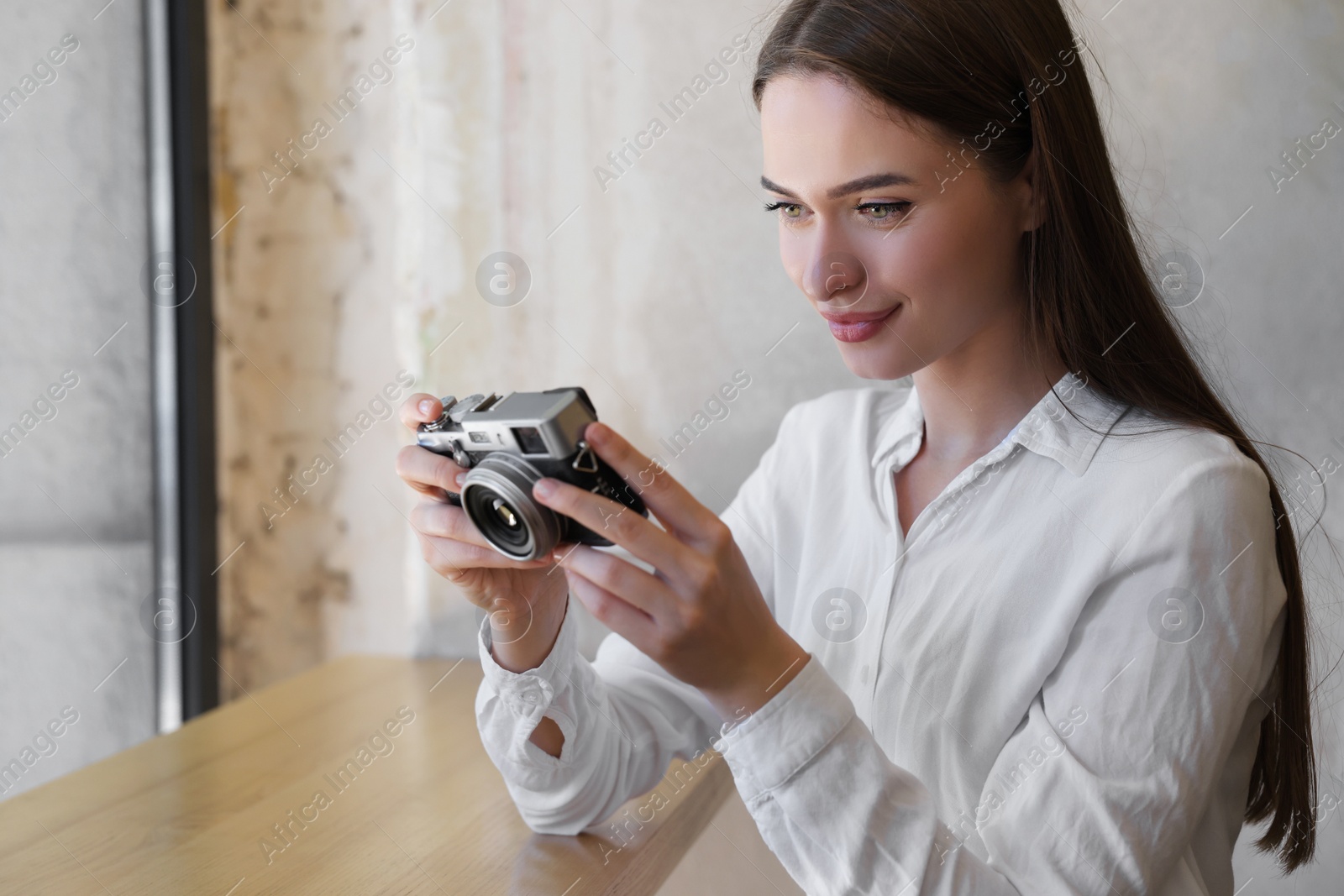 Photo of Young woman taking photo at cafe, space for text. Creative hobby