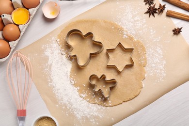 Photo of Making Christmas cookies. Flat lay composition with ingredients and raw dough on white table