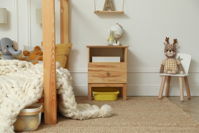 Stylish child room interior with wooden furniture