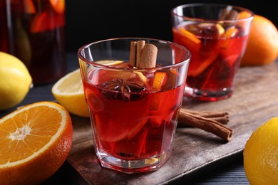 Photo of Aromatic punch drink and ingredients on table, closeup