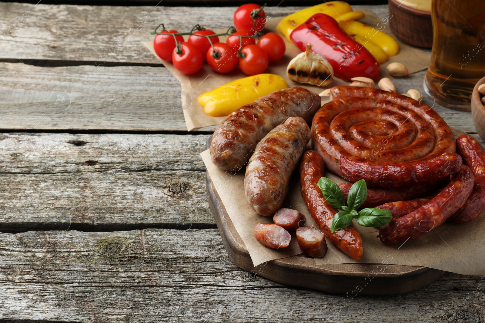 Photo of Set of different tasty snacks on wooden table, space for text