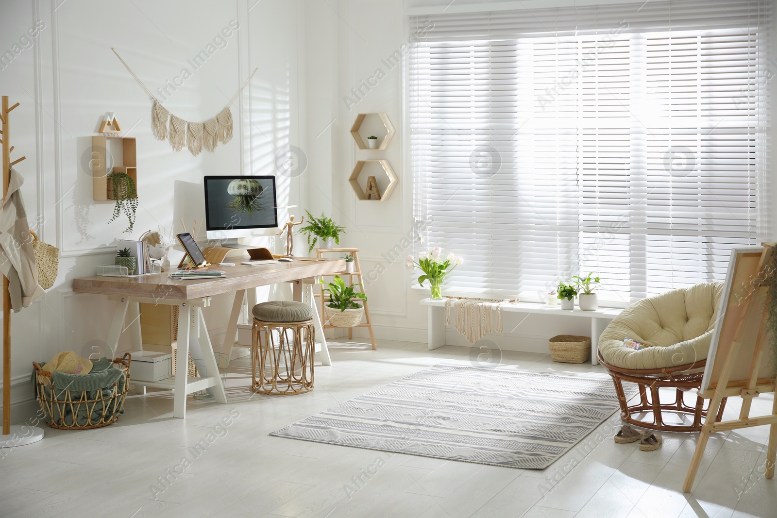 Photo of Stylish home office interior with comfortable workplace and papasan chair