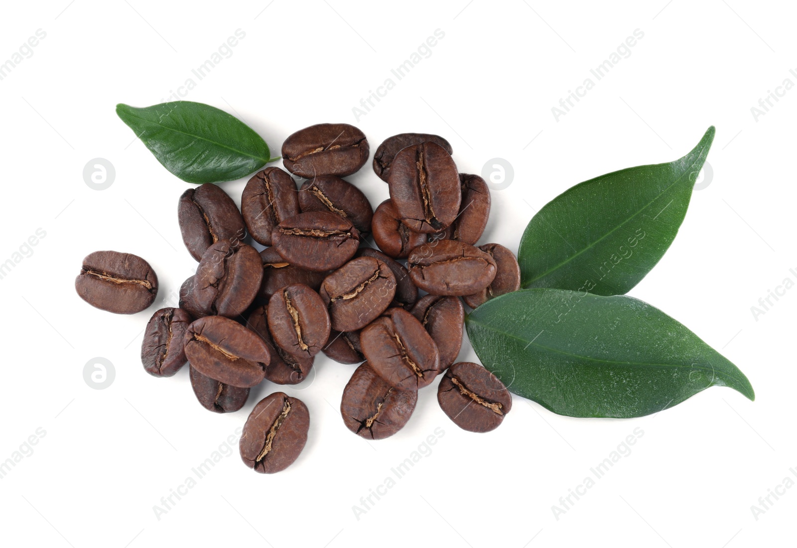 Photo of Pile of roasted coffee beans with fresh leaves on white background, top view