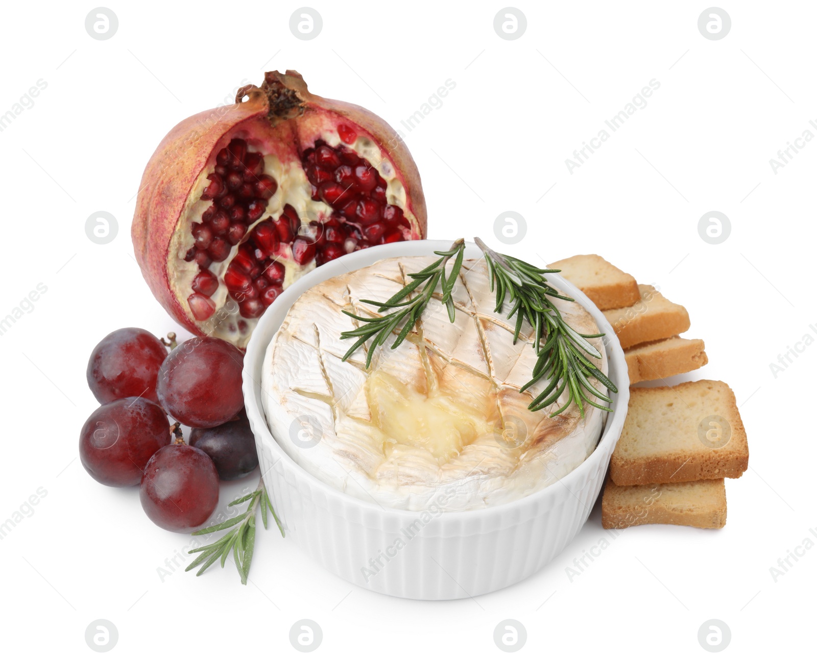 Photo of Tasty baked camembert, croutons, grapes and pomegranate isolated on white