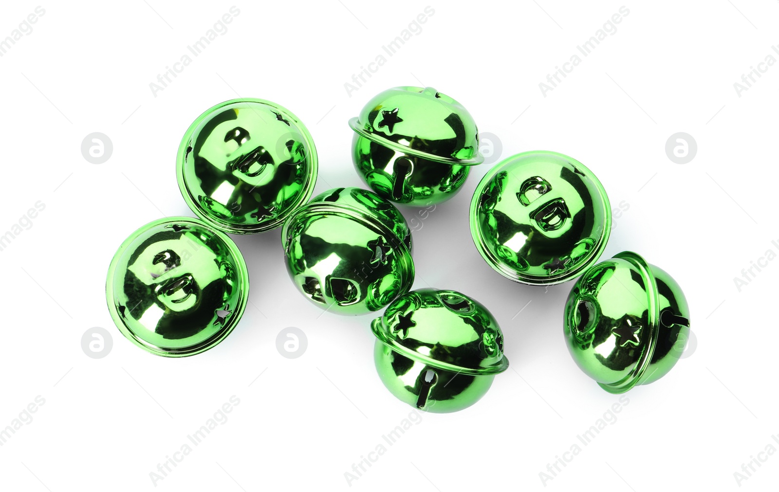 Photo of Shiny green sleigh bells on white background, top view