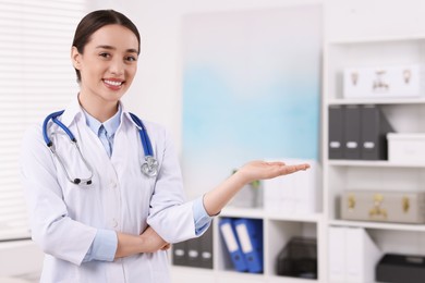 Photo of Medical consultant with stethoscope in clinic, space for text