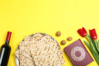 Photo of Flat lay composition with matzos on yellow background, space for text. Passover (Pesach) celebration