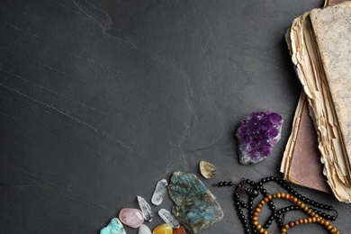 Photo of Flat lay composition with different gemstones on black background. Space for text