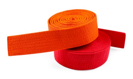 Photo of Orange and red karate belts isolated on white