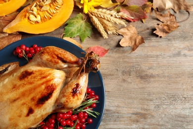 Flat lay composition with delicious turkey on wooden background, space for text. Happy Thanksgiving day