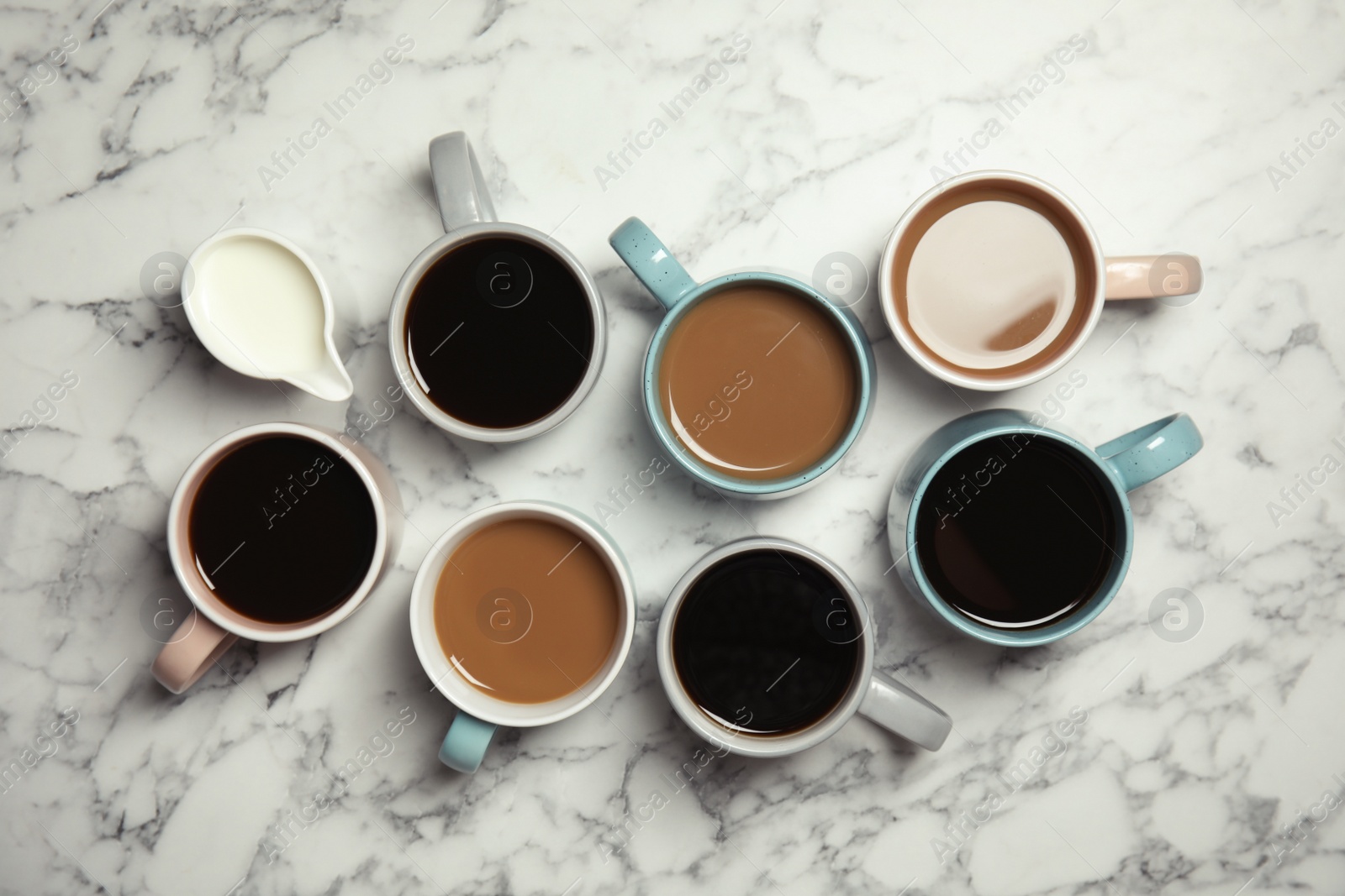 Photo of Flat lay composition with cups of coffee on marble background. Food photography