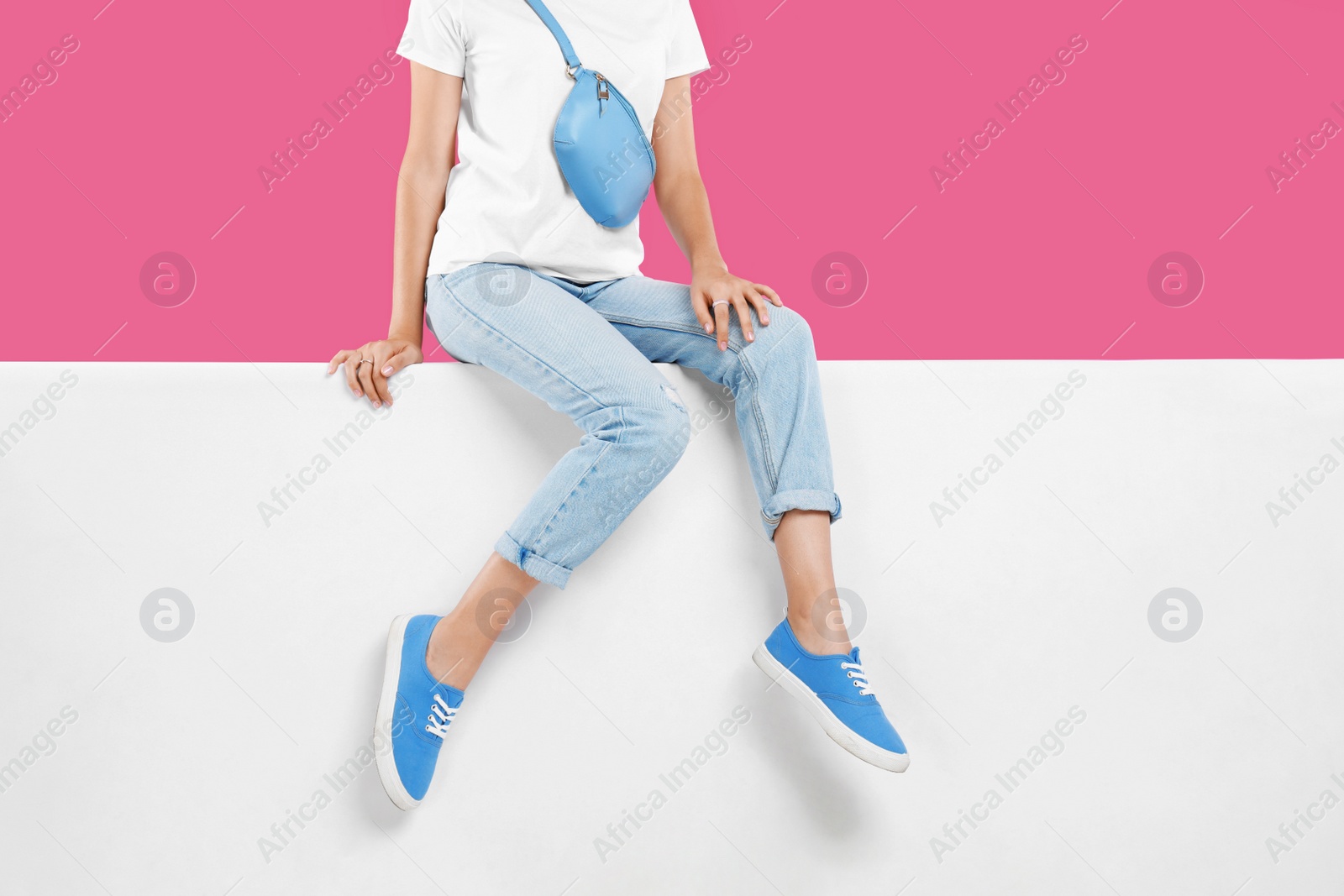 Photo of Woman wearing stylish shoes on color background, closeup