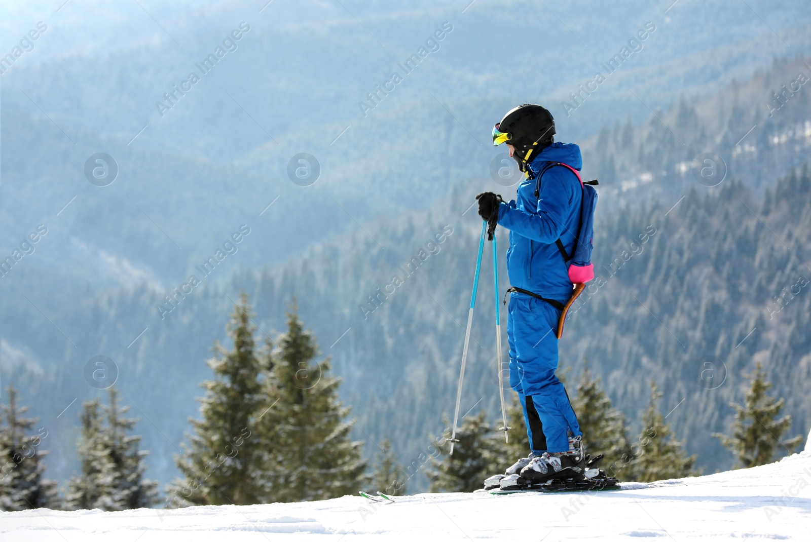 Photo of Man skiing on snowy hill in mountains, space for text. Winter vacation