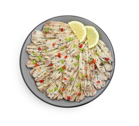 Tasty pickled anchovies with spices and lemon isolated on white, top view