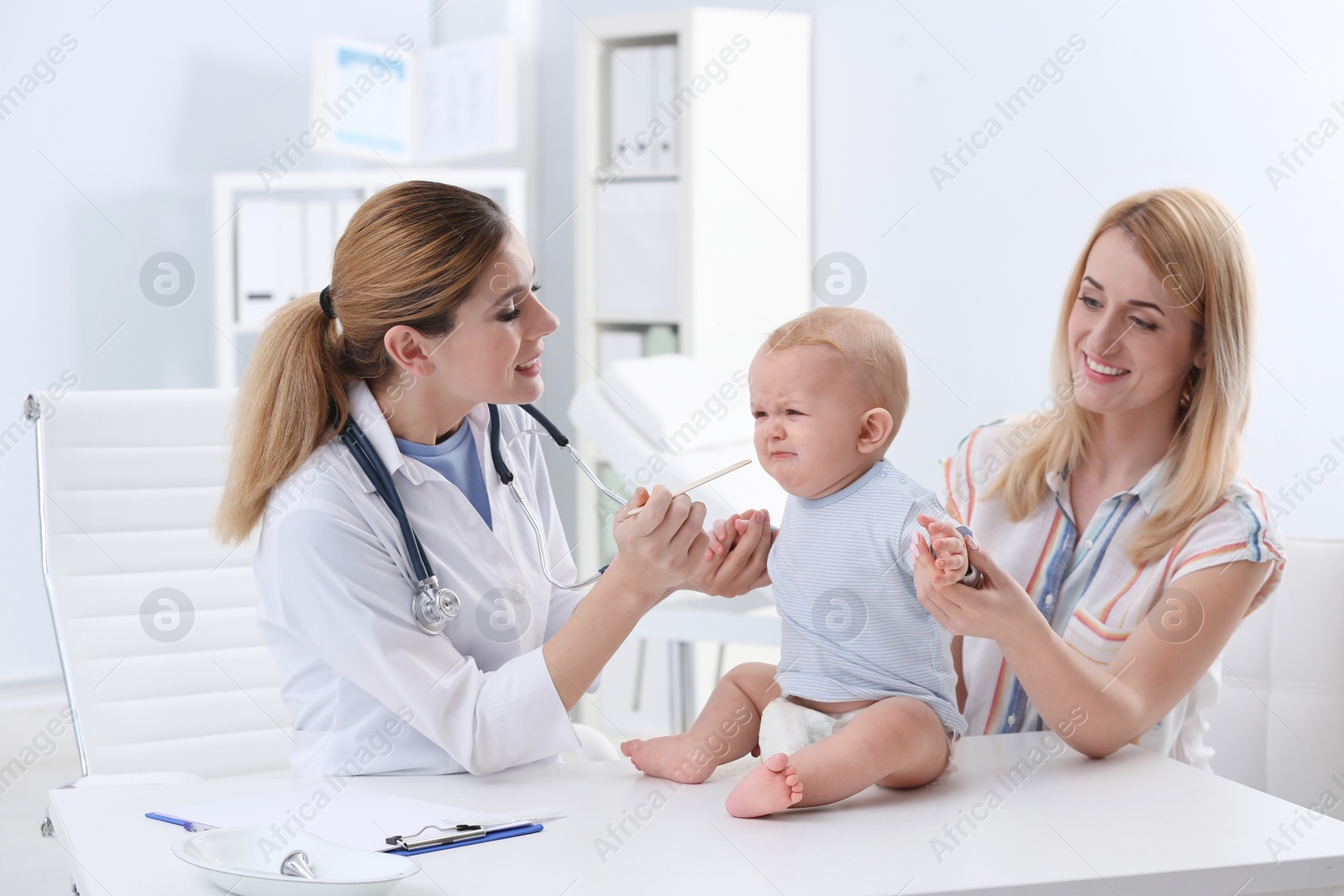 Photo of Woman with her baby visiting children's doctor in hospital