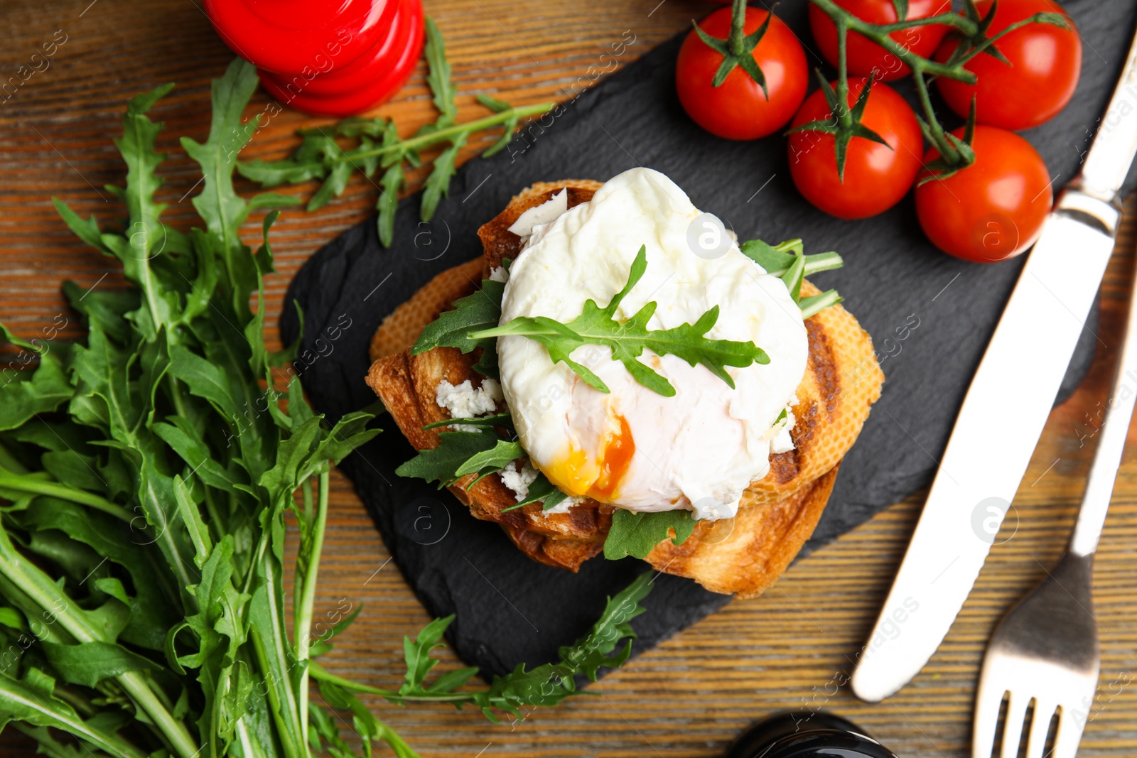 Photo of Delicious sandwich with arugula and egg on wooden table, flat lay