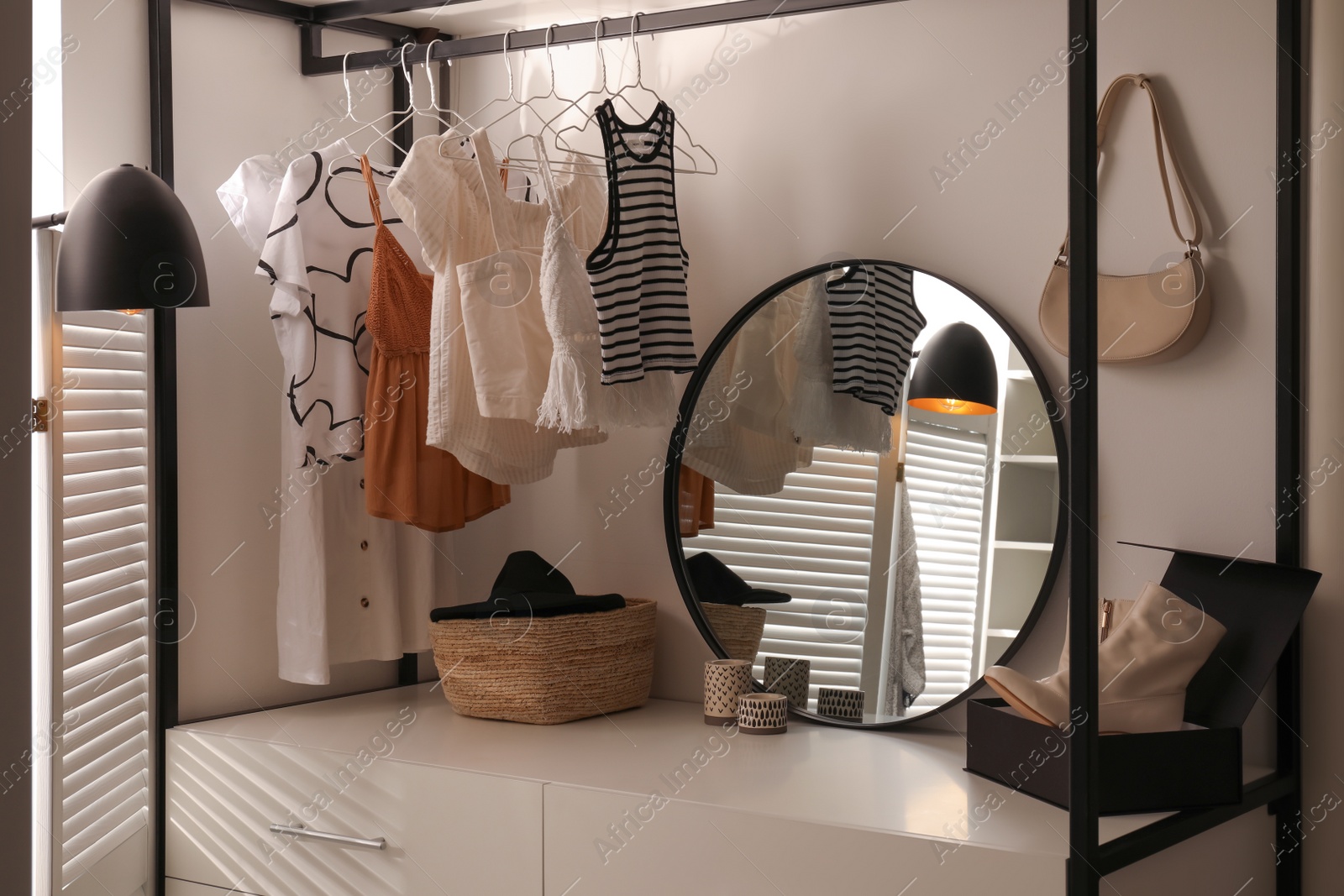 Photo of Dressing room interior with storage rack for shoes and accessories