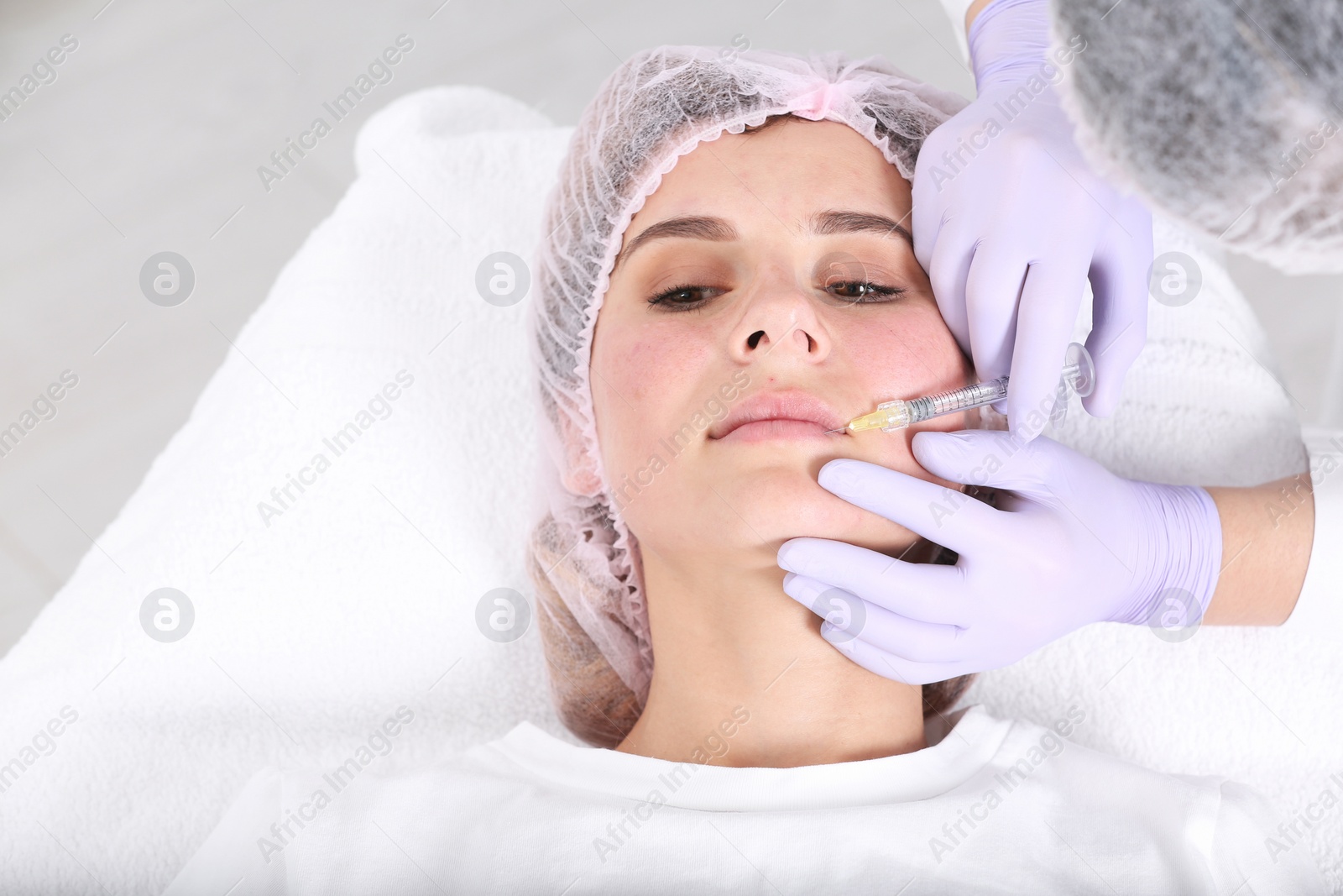 Photo of Woman undergoing face biorevitalization procedure in salon. Cosmetic treatment