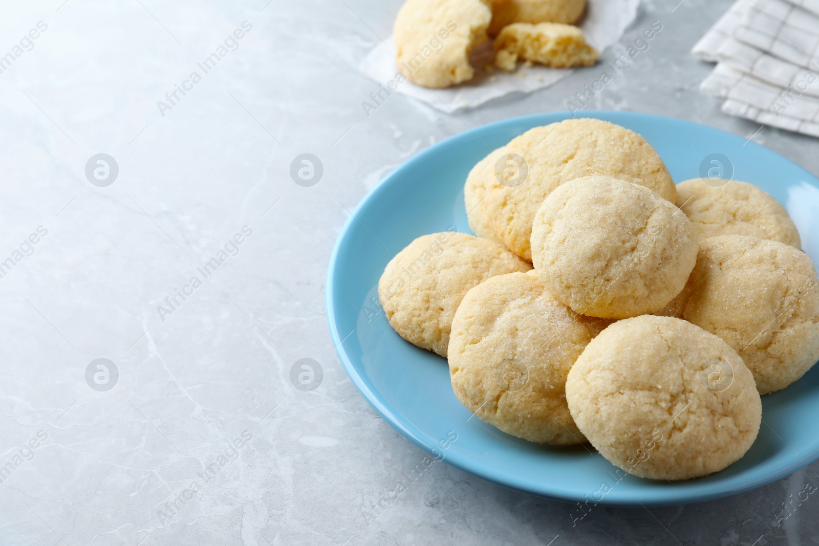 Photo of Delicious sugar cookies on light grey marble table, space for text