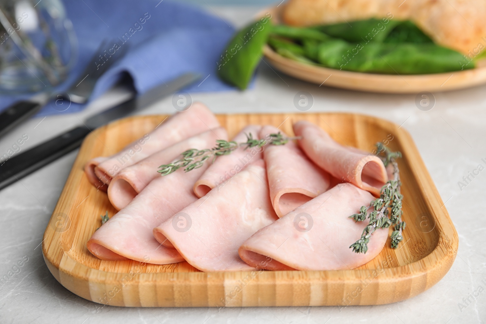 Photo of Tasty fresh ham on light grey marble table