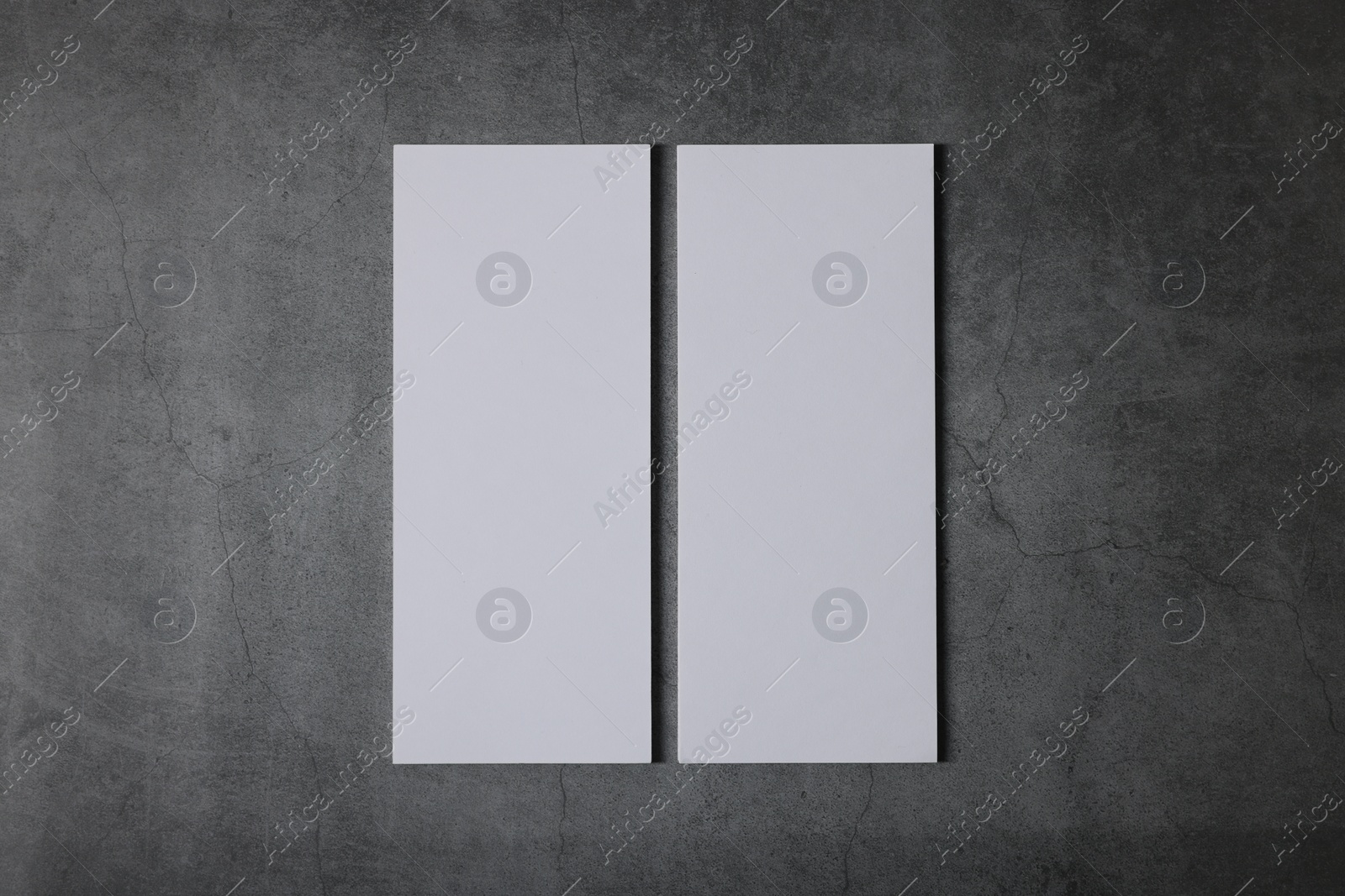 Photo of Blank business cards on grey textured background, top view. Mockup for design