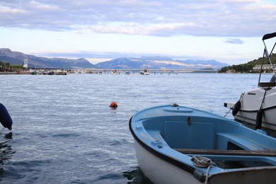 Trogir, Croatia - September 24, 2023: Picturesque view of moored boats, mountains and sea on cloudy day