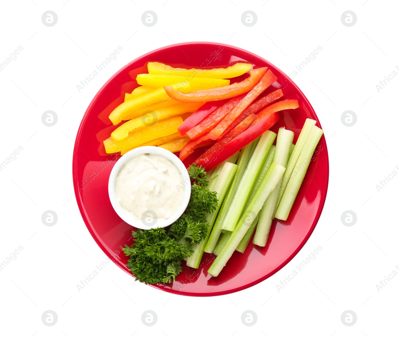 Photo of Plate with dip sauce, celery and other vegetable sticks isolated on white, top view