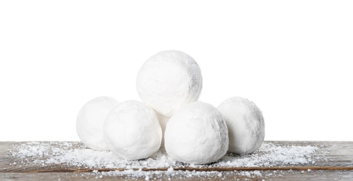 Snowballs on wooden table against white background
