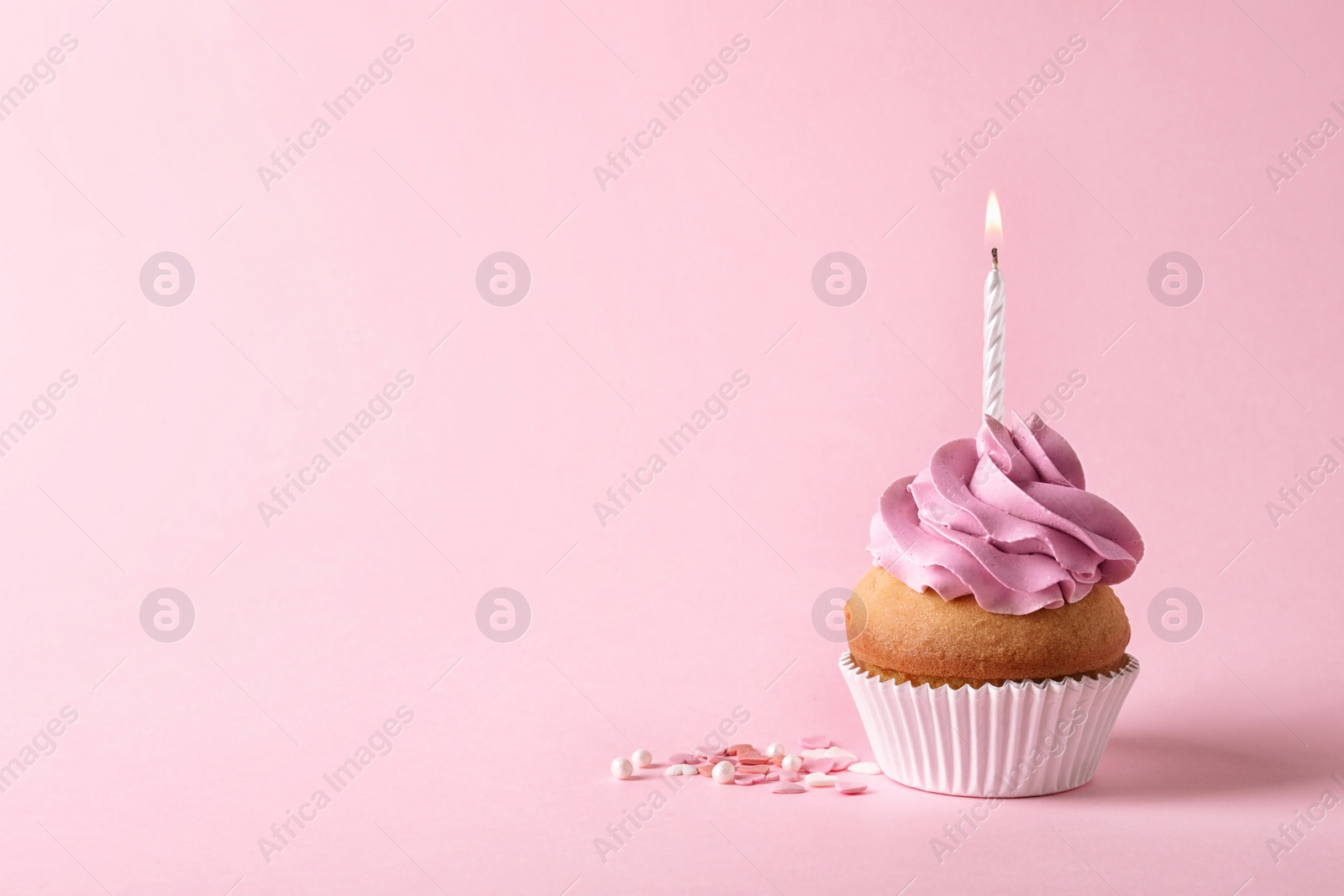Photo of Delicious birthday cupcake with candle and space for text on color background