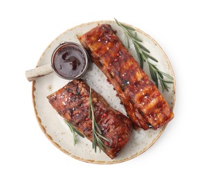 Photo of Tasty roasted pork ribs, sauce and rosemary isolated on white, top view